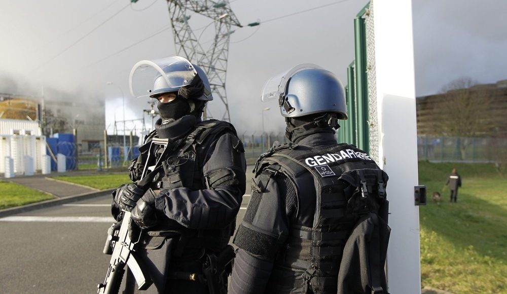 French riot gendarmes pose for the media in front of the Chinon Nuclear Power Plant in Chinon